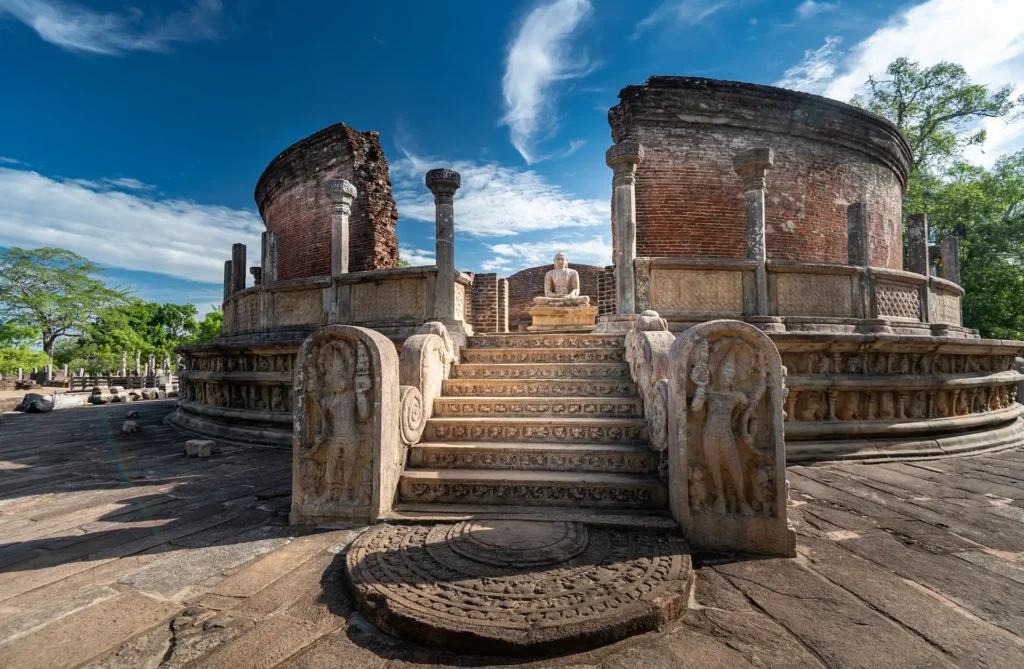 The beautifully preserved stone stairs and seated Buddha statue at the Polonnaruwa Vatadage, a fascinating ancient historical site to explore on our 1-day excursions Sri Lanka.