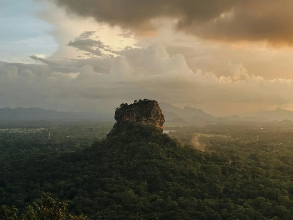 Panoramic view of the ancient Sigiriya Lion Rock fortress surrounded by lush jungle, a highlight of our Sigiriya and Dambulla day tour.